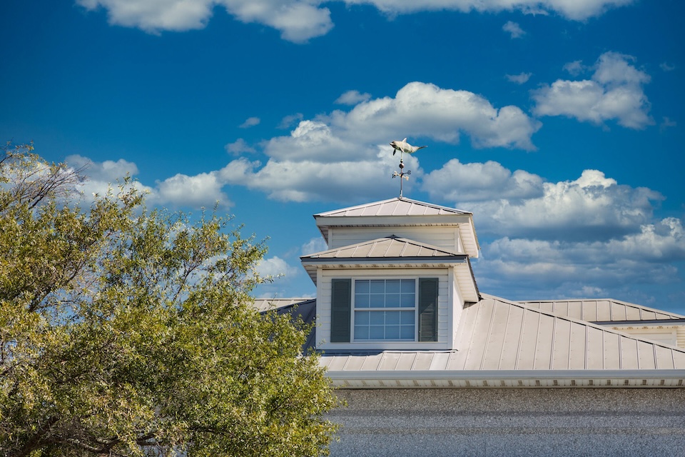 metal roof on house with cloudy blue sky background