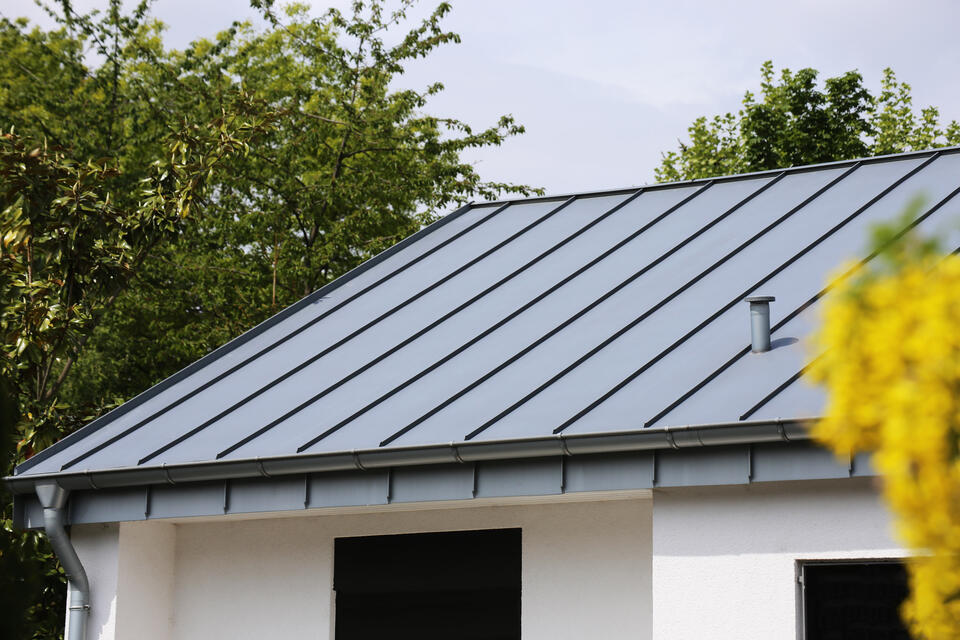 metal roofing stuart fl-gray standing seam metal roof on white house